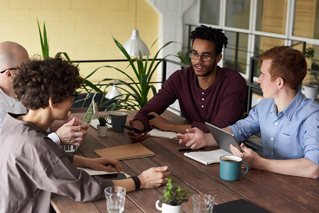man sitting in table with other the mastermindcbm Our Approach model